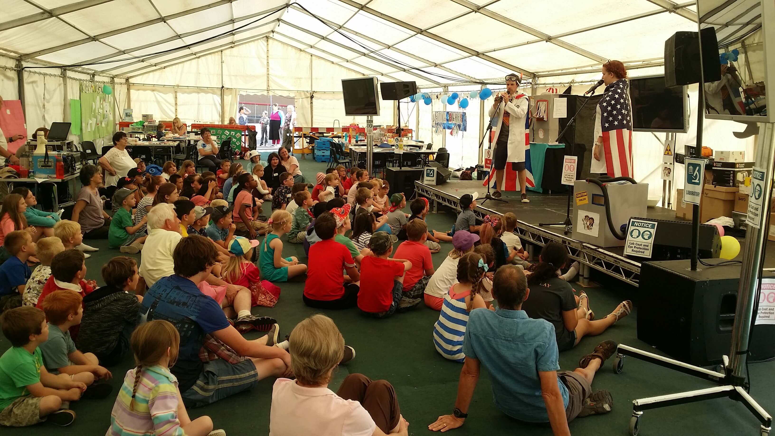 Crowd of people sitting at The Big Tent event