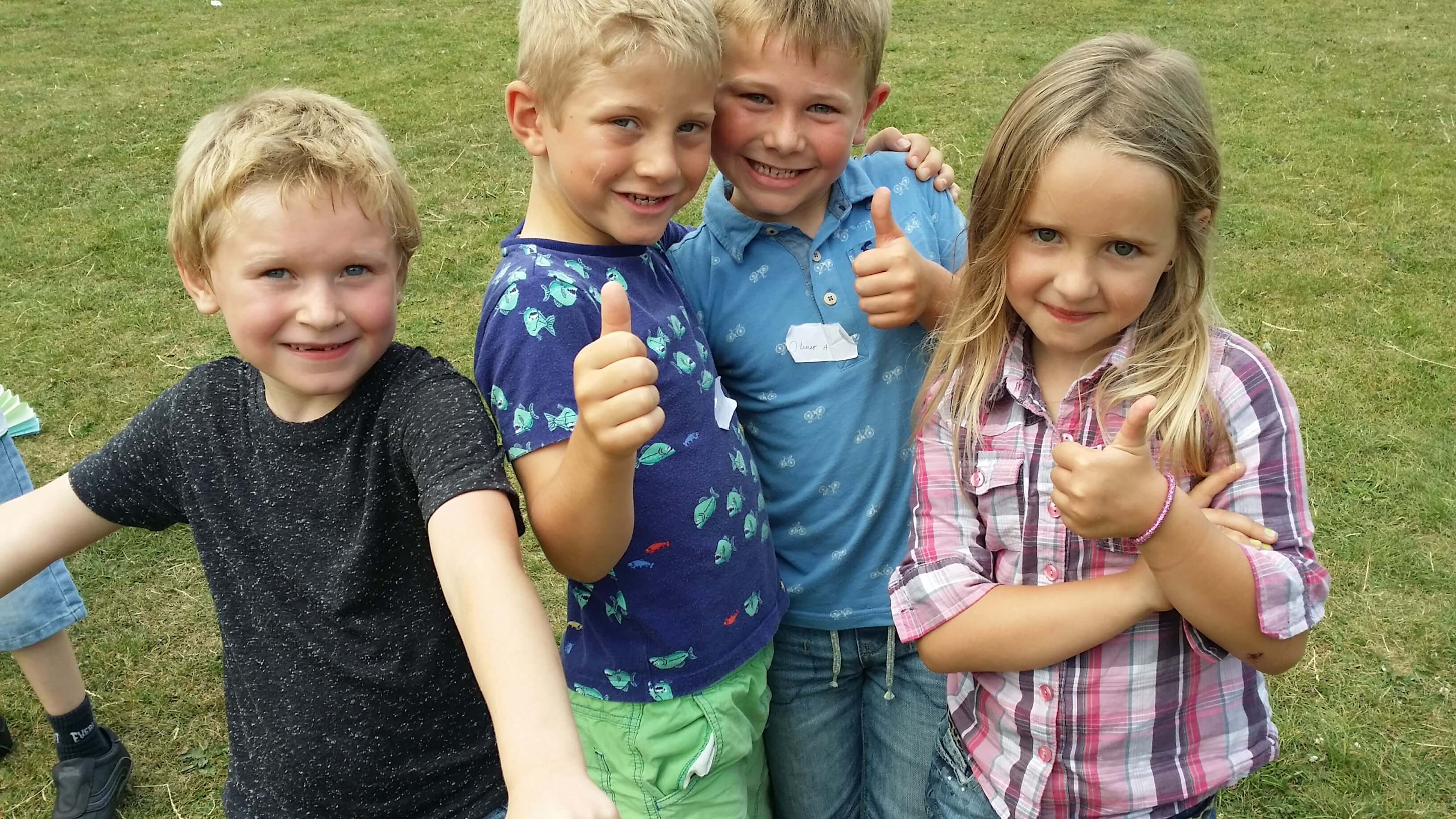 Group of kids giving a thumbs up