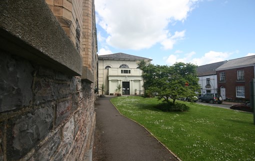 Side view of church hall looking down the lawn towards the main church building
