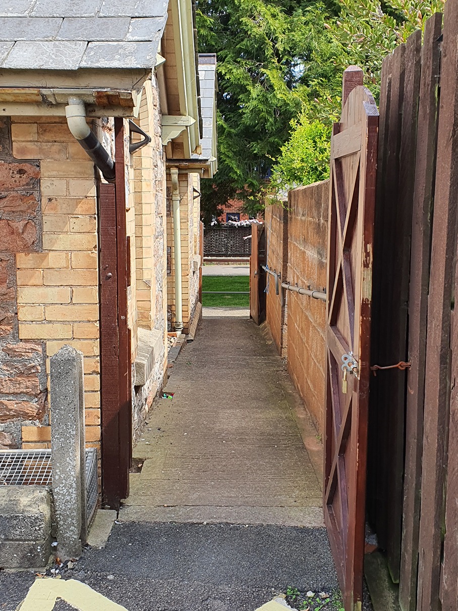 Access from carpark to site showing a slightly sloped ramp with flat concrete surface